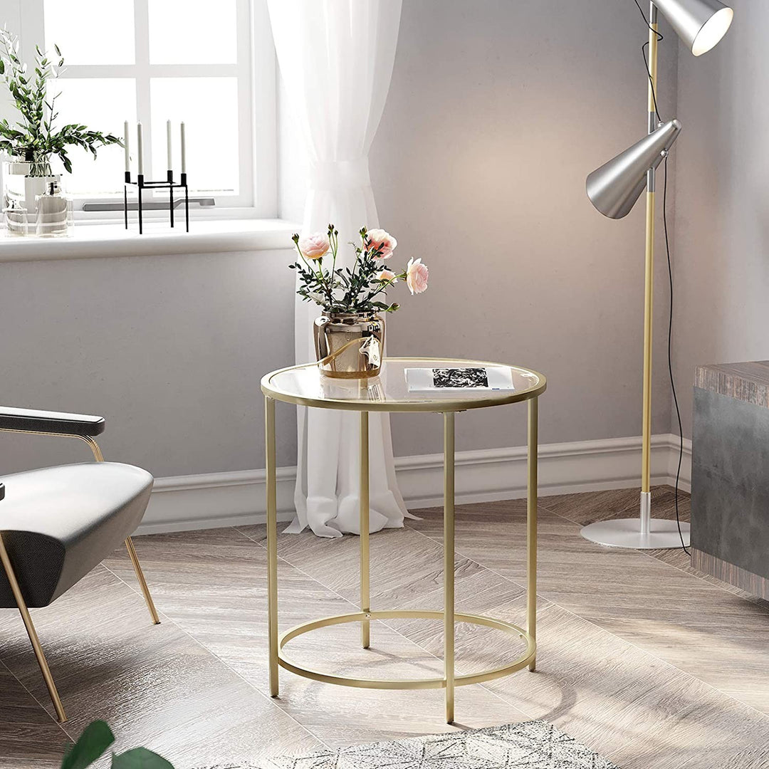 Rundt sofabord i glas med guldfarvet kant