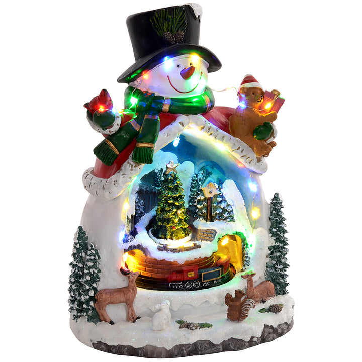 Snemandsformet julelandsby med kørende tog, led-lys og musik, festlig borddekoration, flerfarvet