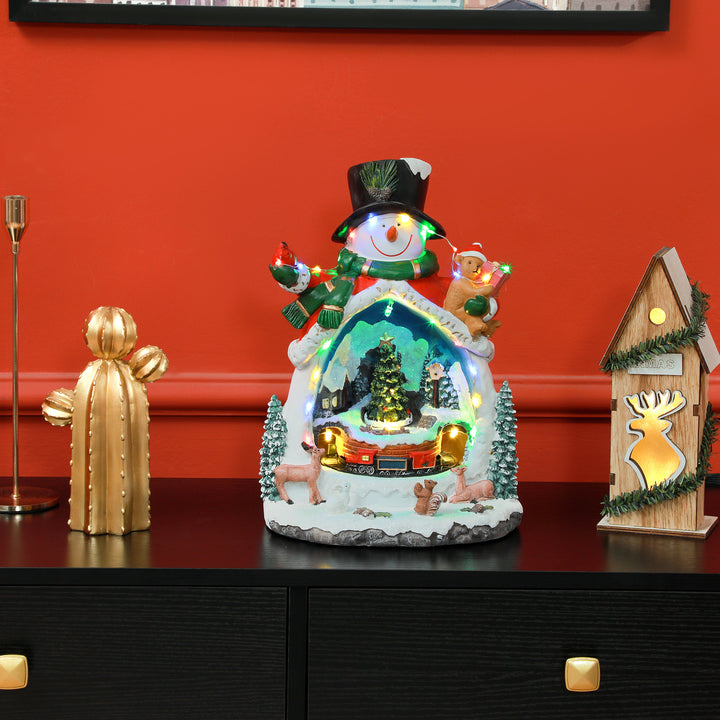 Snemandsformet julelandsby med kørende tog, led-lys og musik, festlig borddekoration, flerfarvet