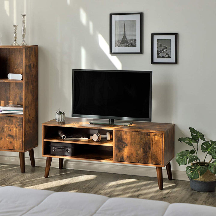 a flat screen tv sitting on top of a wooden stand 