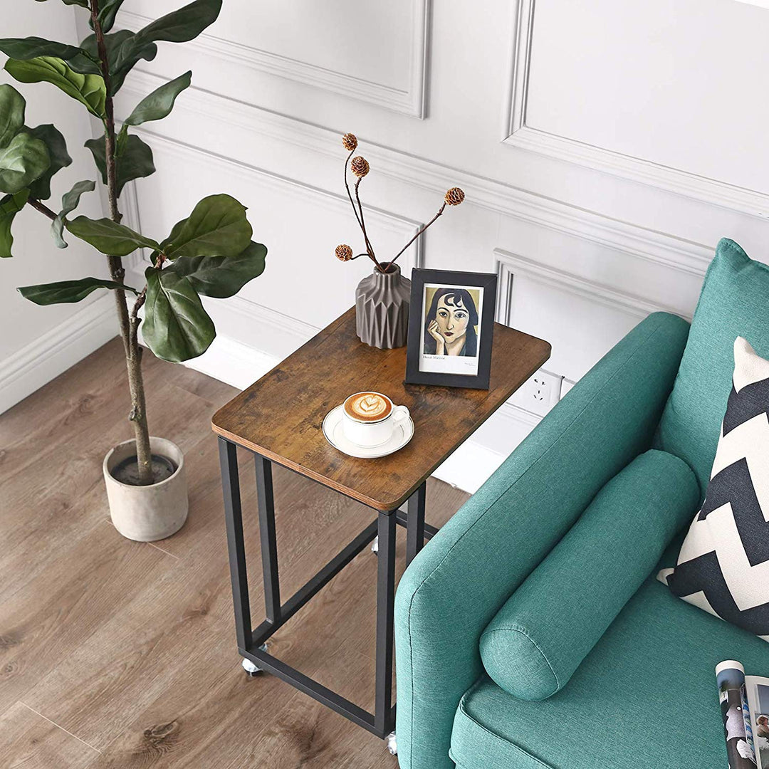 a table with a laptop and a plant on it 